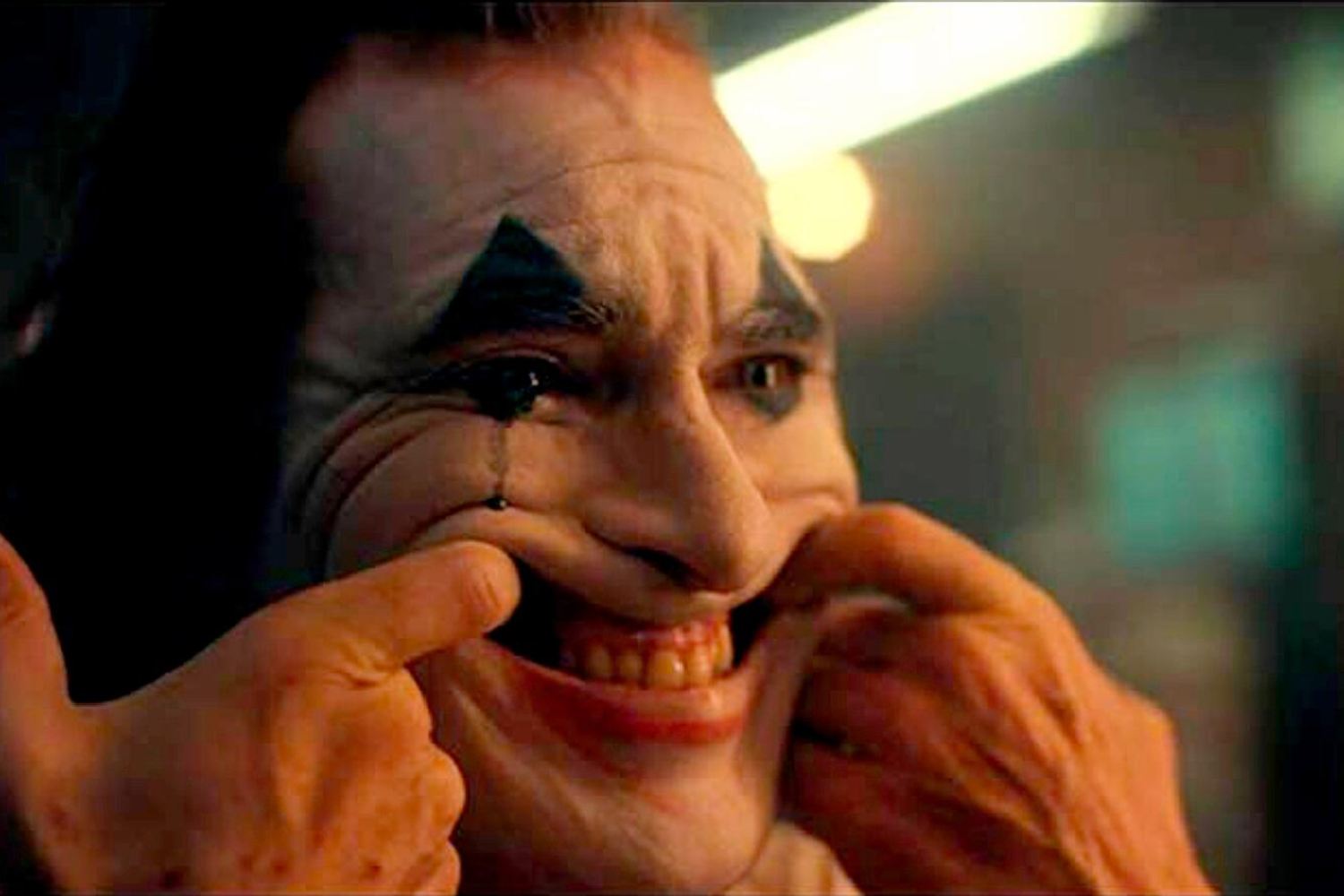 the joker from the movie forcing himself to smile